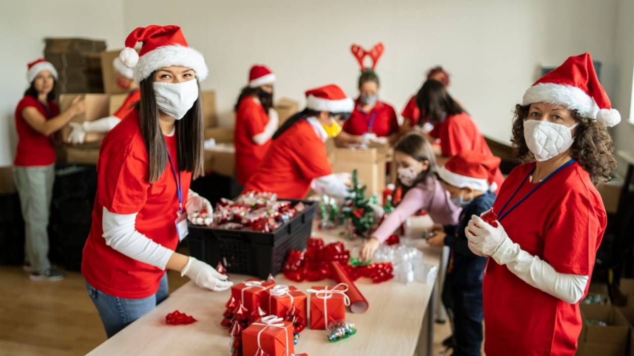 women-volunteering-by-preparation-of-christmas-presents-for-poor-in-picture-id1283399037.jpg