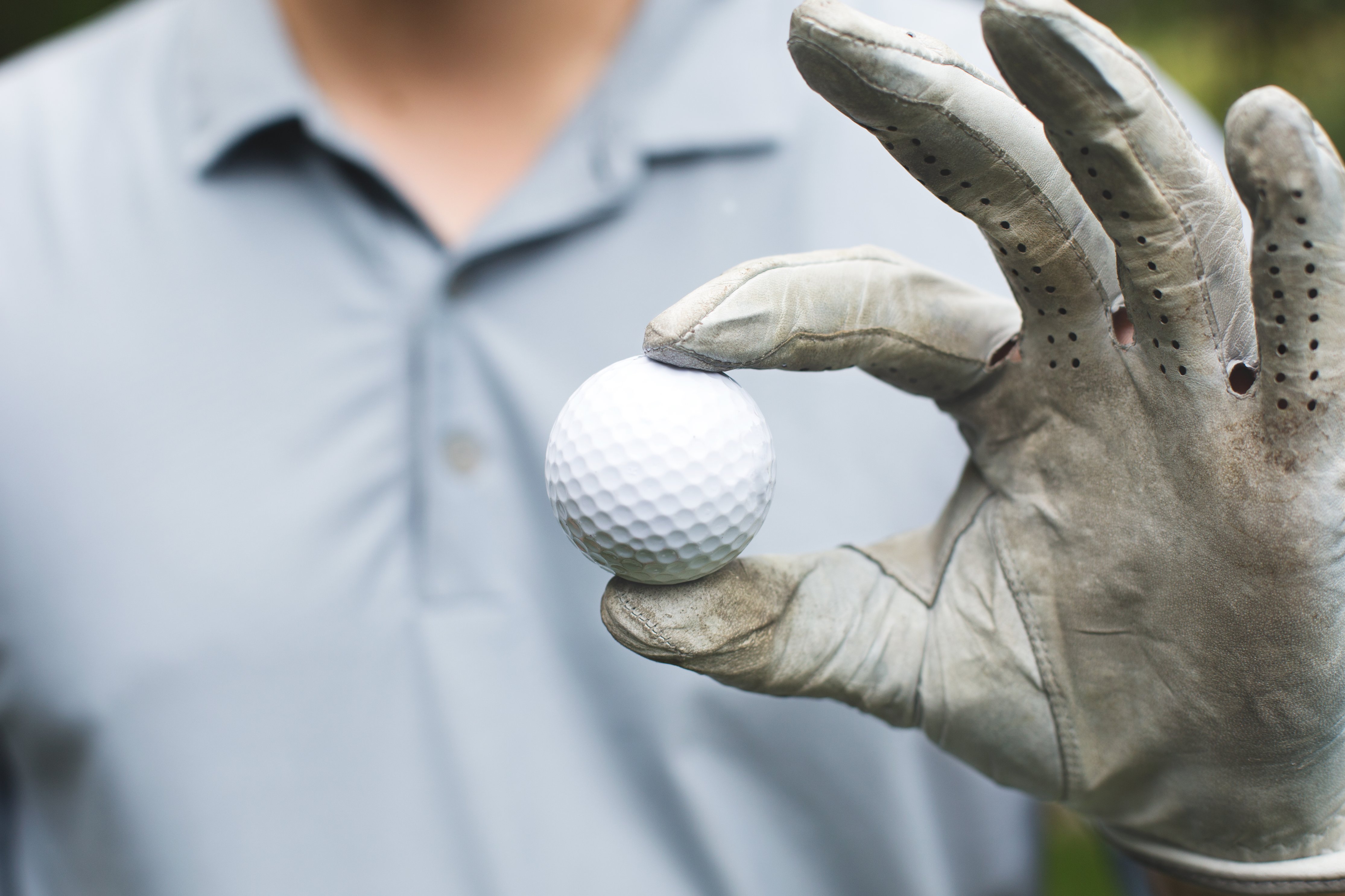 golfer-holds-golf-ball.jpg