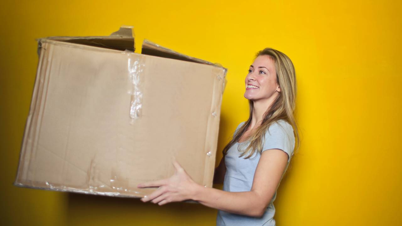 woman-in-grey-shirt-holding-brown-cardboard-box-761999.jpg