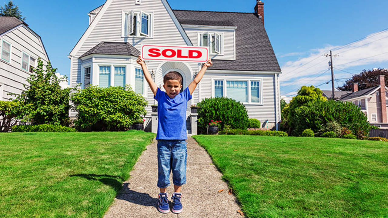 1-Kid_With_Sold_Sign_In_Front_Yard.jpg