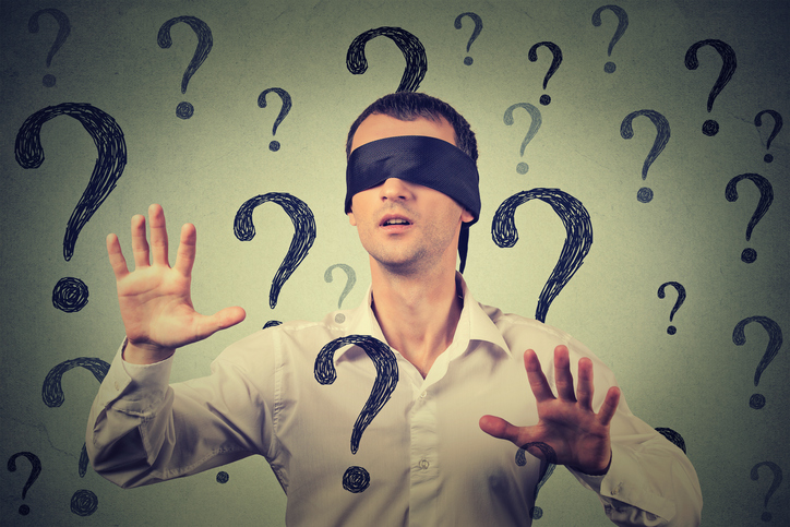 Photo_of_blindfolded_confused_looking_man_surrounded_by_question_marks.jpg