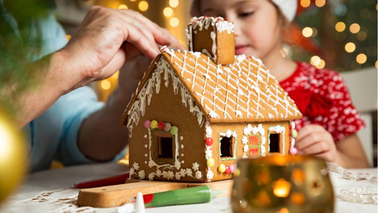 father-and-adorable-daughter-in-red-hat-building-christmas-house-picture-id872810520.jpg