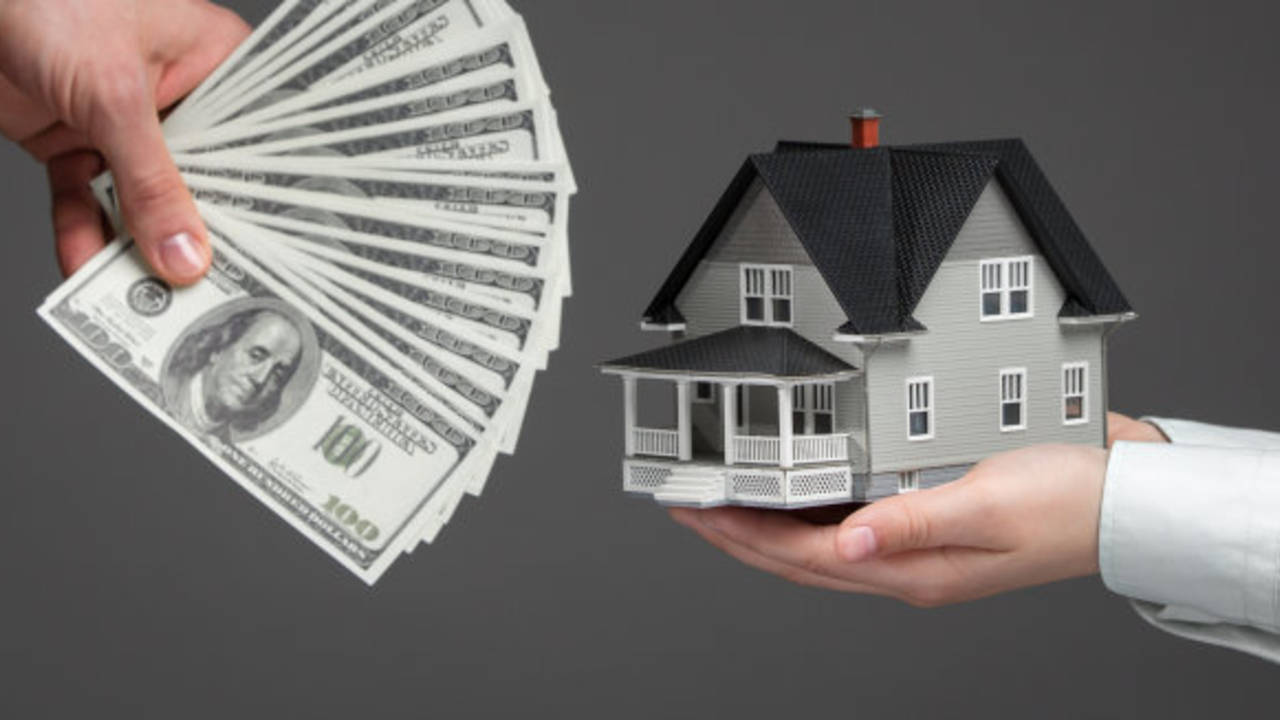 stock-photo-close-up-of-hands-giving-house-model-to-other-hands-with-money-concept-of-real-estate-and-deal-165551312.jpg