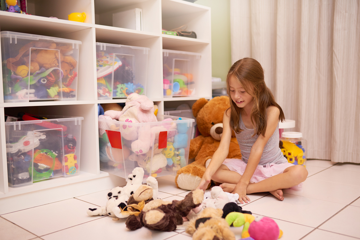 Young Girl Organizing Stuffed Toys