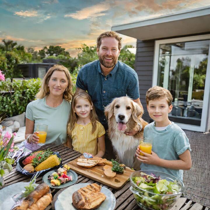 Firefly_new_home_in_florida__family_with_kids_outside_on_the_deck__dad_cooking_at_the_grill__table_w.jpg