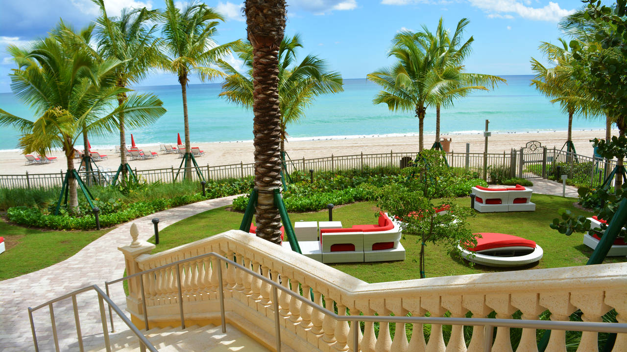 Mansions_At_Acqualina_grand_staircase_leading_to_oceanfront_garden.jpg