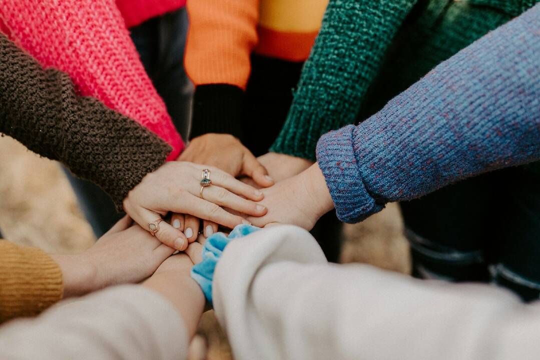 person_in_red_sweater_holding_babys_hand.jpg
