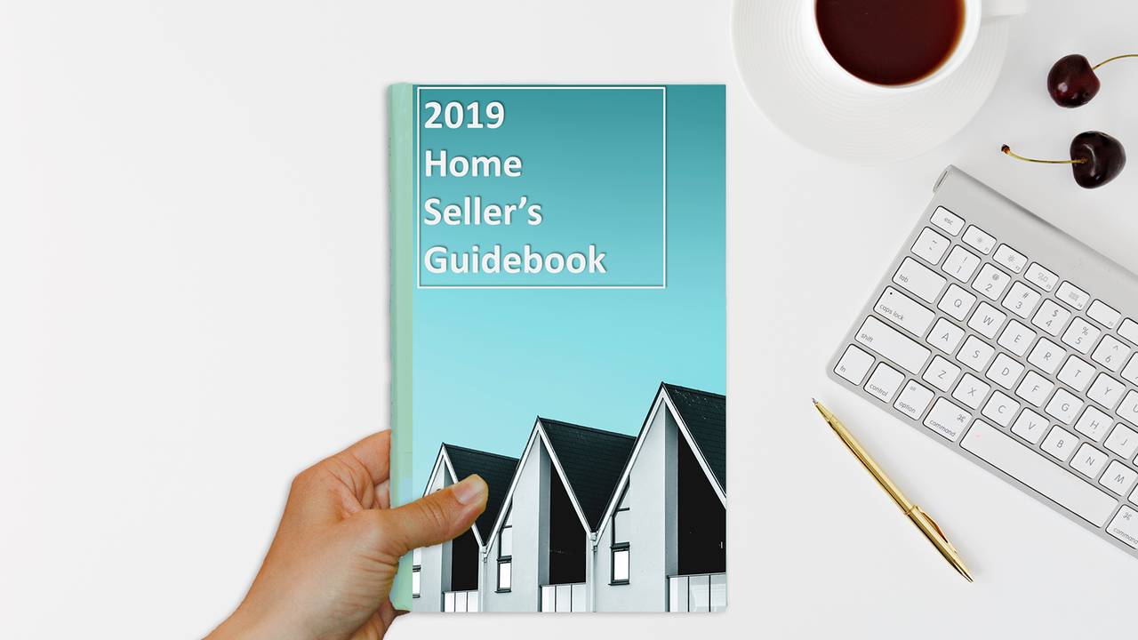 hand_holding_2019_home_sellers_guidebook.png